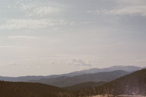 Free Tranquil mountain landscape with hazy sky and gentle cloud cover. Stock Photo