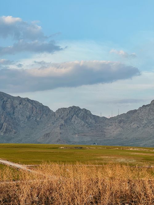 Free A breathtaking view of Qurago's rugged mountains and valley under a clear blue sky. Stock Photo