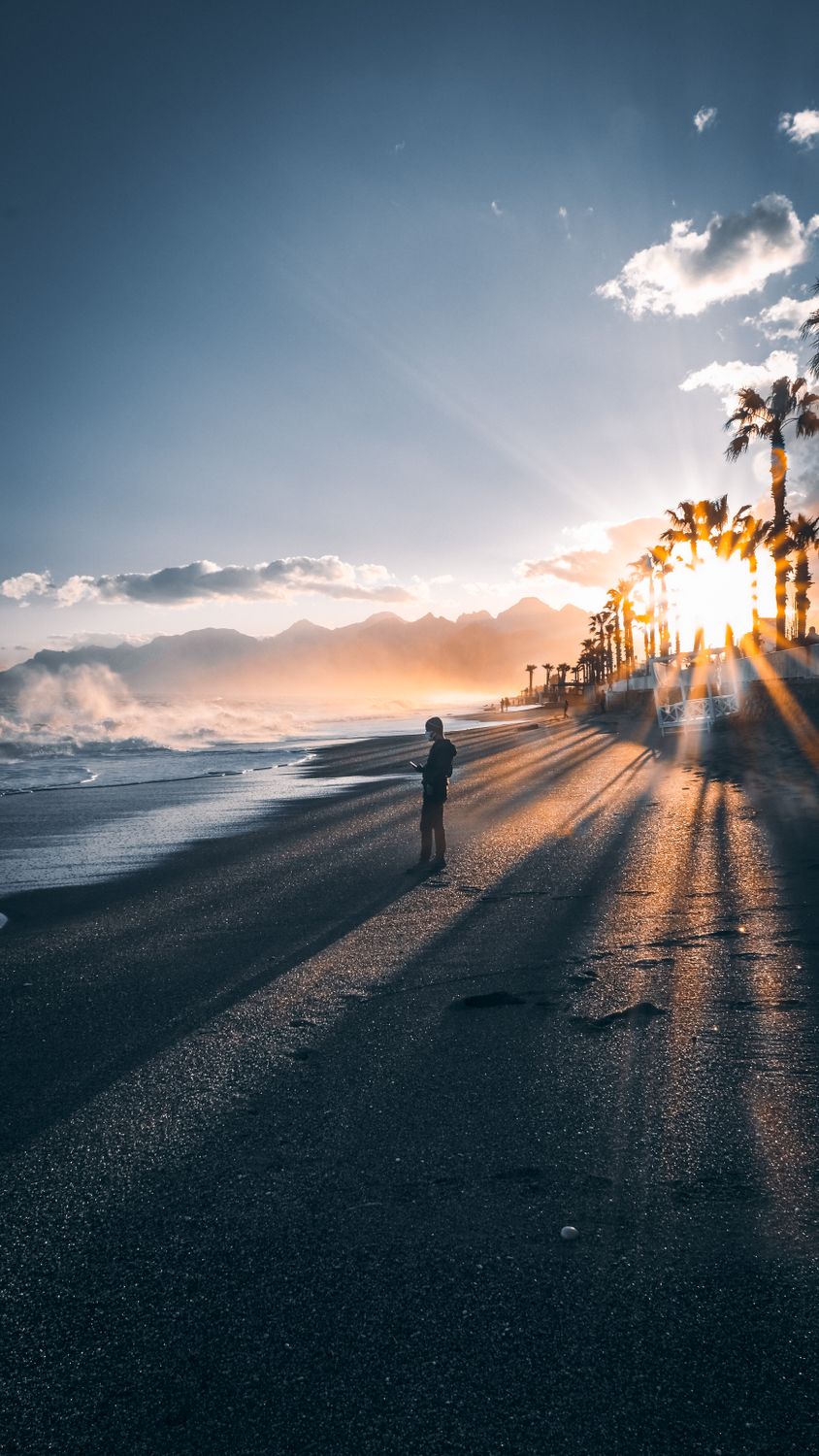 Man Walking on Beach on Sunset · Free Stock Photo