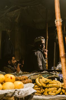 A bustling marketplace in Punjab, Pakistan featuring fruit sellers and vibrant produce.