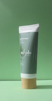 Sophisticated body cream tube with bamboo cap on a green backdrop. Ideal for beauty and cosmetic themes.