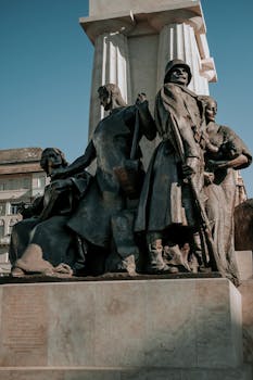 Captivating stone and bronze monument under clear sky in European city.