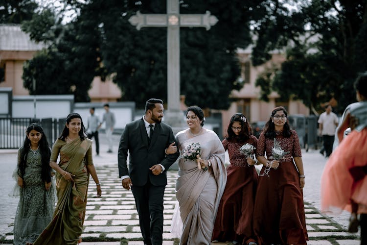 Newlyweds And People Walking Together