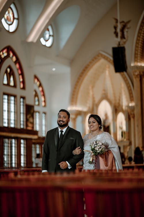 Newlyweds Walking and Smiling in Church