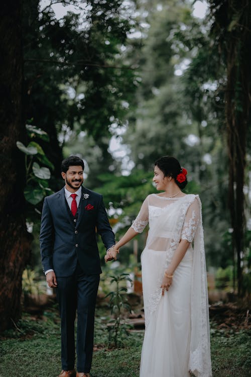 Smiling Woman and Man in Wedding Dress and Suit