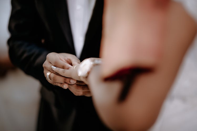 Newlyweds Putting Rings On Hands On Wedding