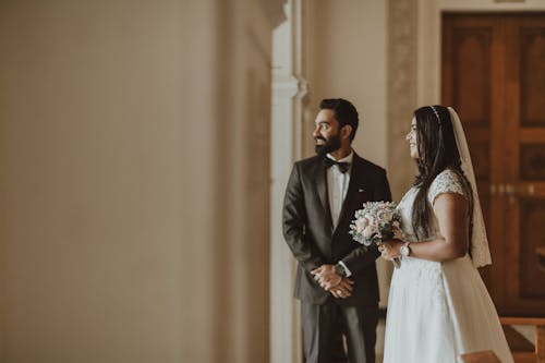 Newlyweds Posing by Wall