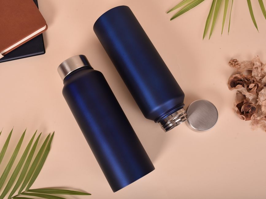 Photo by ashish sagar on Pexels Stylish blue insulated sport bottles accompanied by notebooks and natural leaves for a modern still life composition.