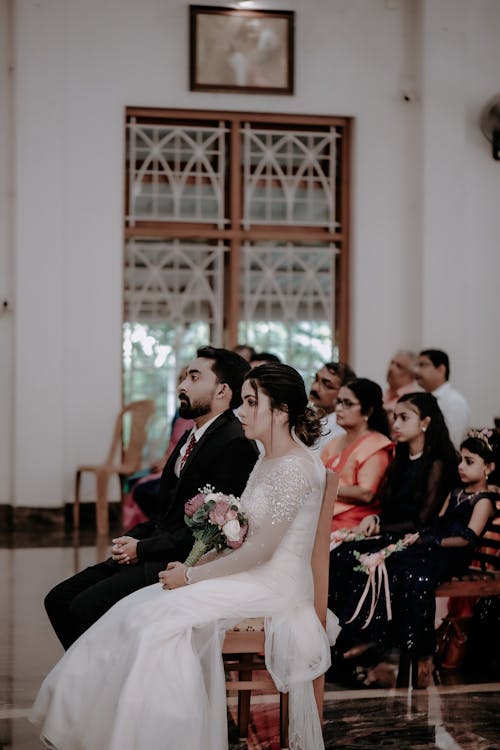 Bride and Bridegroom Sitting in a Church during a Wedding Ceremony 