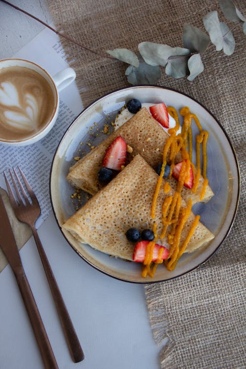 Free Plate with Crepes and a Cup of Coffee Stock Photo