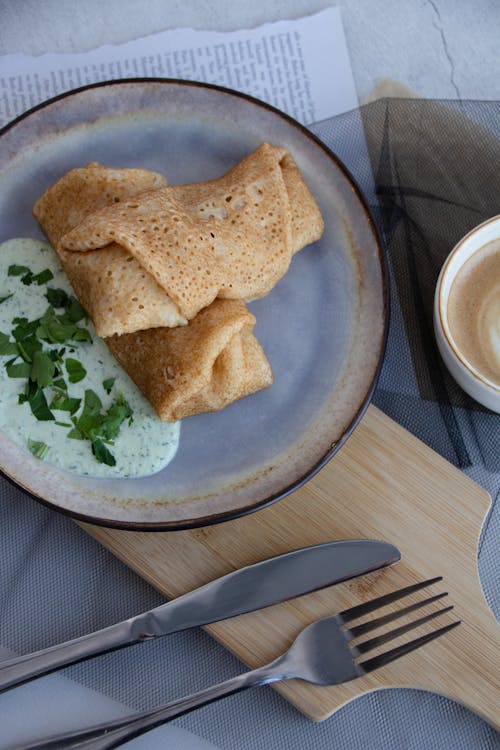 Free Crepes on a Plate and Cutlery Stock Photo