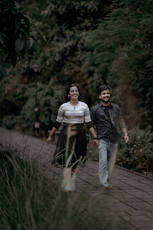 Free Happy Couple Walking on Sidewalk Stock Photo