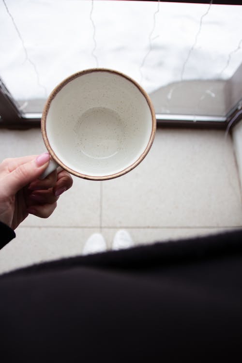 Woman Hand Holding Empty Cup · Free Stock Photo
