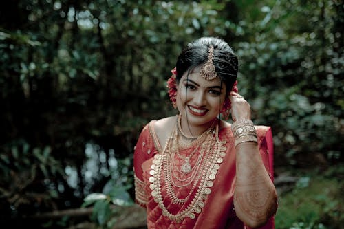 Smiling Bride in Traditional Dress in Park