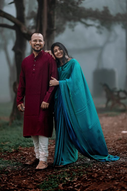 Smiling Bride and Groom in Traditional Clothes in Nature