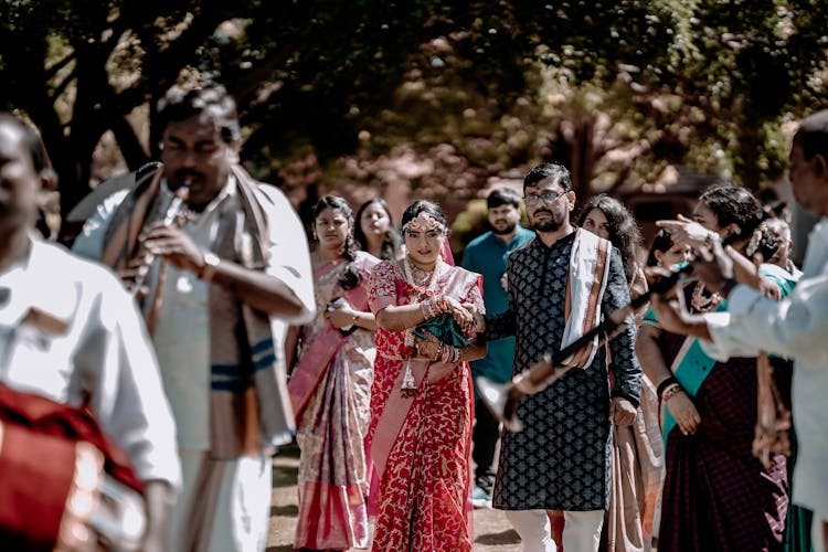 Indian Newlywed Couple And Wedding Guests And Musicians At A Wedding Celebration 