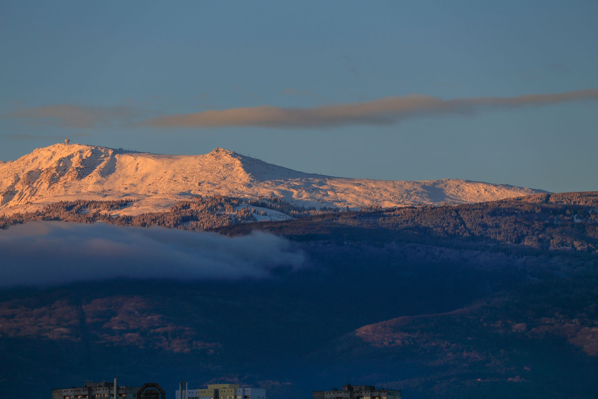 Majestic view of Vitosha Mountain covered in snow at sunrise over Sofia, Bulgaria.