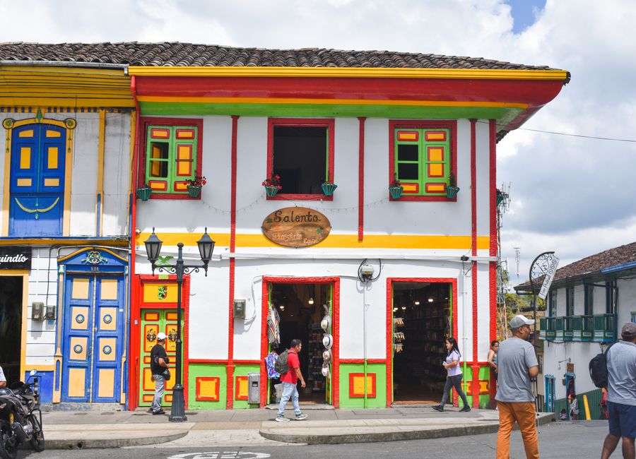 Vibrant colonial architecture on a bustling street in Salento, Colombia.