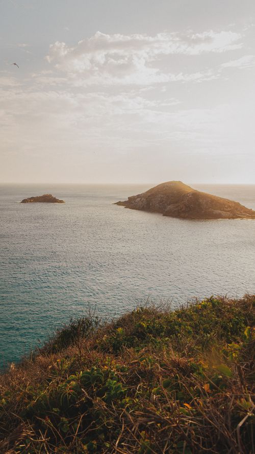 Free Serene view of islands in the sea at sunset, offering a peaceful horizon and warm tones. Stock Photo