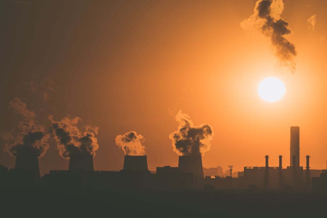 Morning shot of powerplants burning fuel with columns of smoke rising