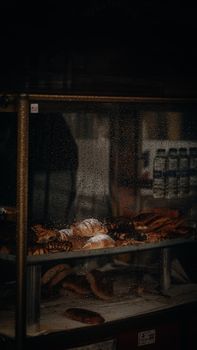 Dark showcase of artisan bread and pastries in an İstanbul bakery.