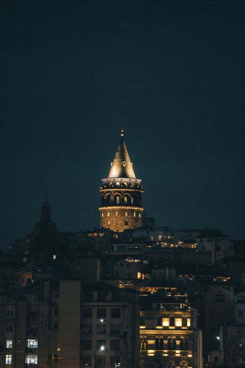 Free Stunning night view of the illuminated Galata Tower in Istanbul, Türkiye, capturing its historic charm. Stock Photo