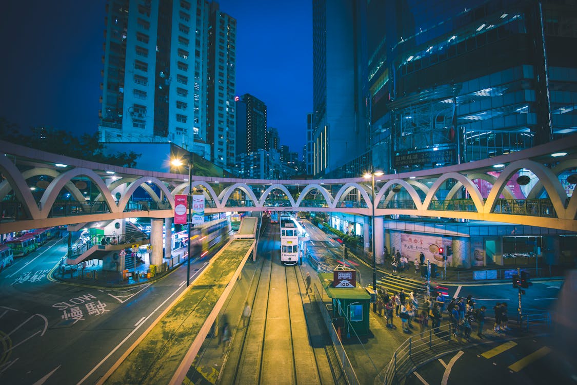 Group of People Walking Under the High Rise Buildings