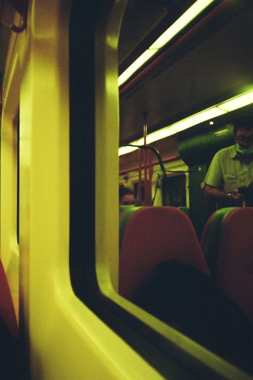 Free A view of a subway train interior at night, highlighting reflections on the window. Stock Photo