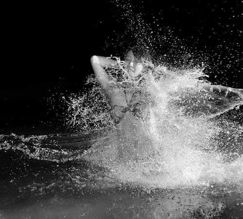 Woman in Bikini in Body of Water in Grayscale Photography