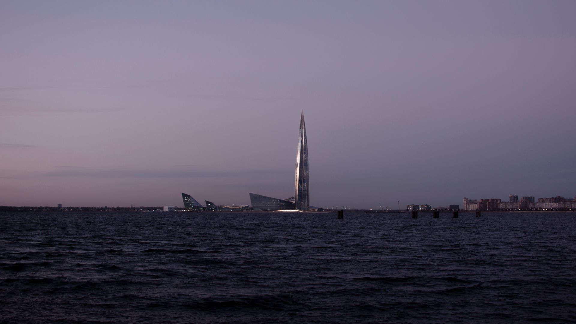 Capture of Lakhta Center skyscraper at twilight, overlooking a calm sea in St. Petersburg, Russia.