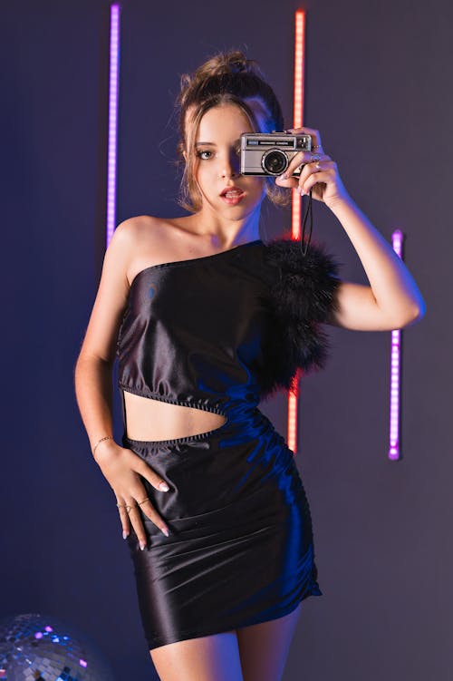 Young Model Taking a Picture with Vintage Camera