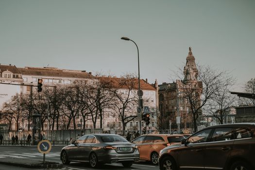 Street scene in Budapest with historic architecture, traffic, and winter ambiance.