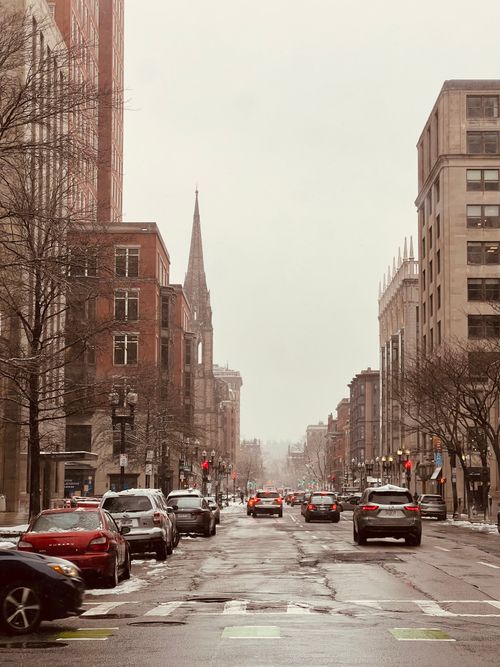 Free Busy winter city street scene with traffic and snowy conditions. Stock Photo