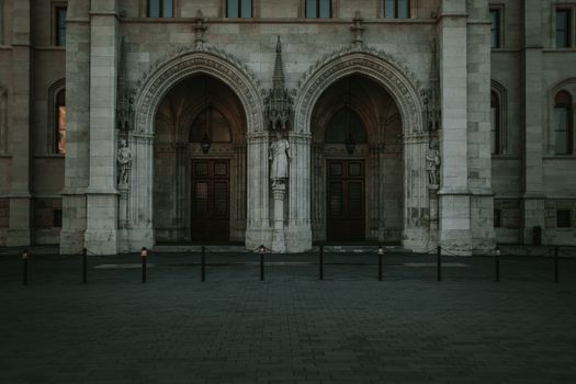Gothic-style building facade in Budapest with intricate arches and statues.