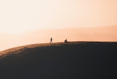 People in Mountains at Dawn