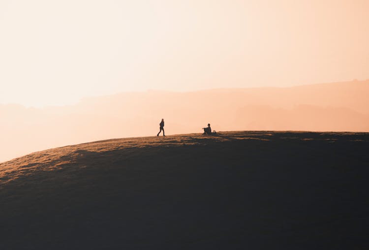 People In Mountains At Dawn