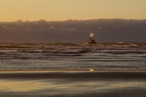 View of a Boat on near a Shore at Sunset