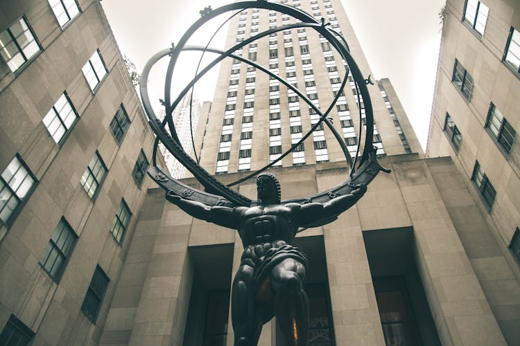 Low-angle Photography Of Atlas Statue