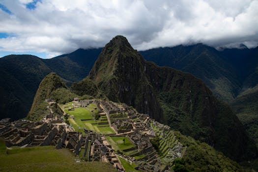 Stunning view of the ancient Incan citadel Machu Picchu surrounded by lush Andean mountains.
