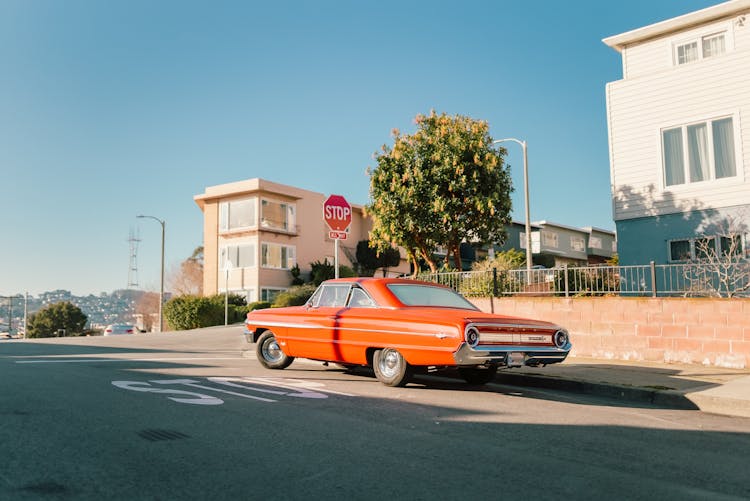 Red Vintage Car Stopped On The Crossroads