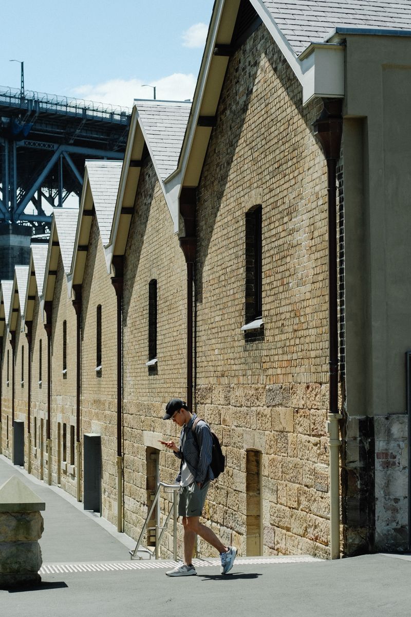 Sandstone buildings of The Rocks with the Harbour Bridge behind