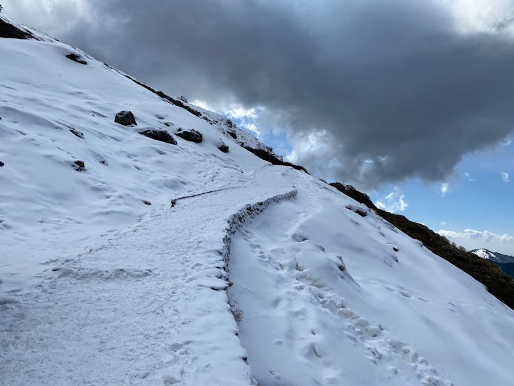 A Steep Mountain Covered In Snow 