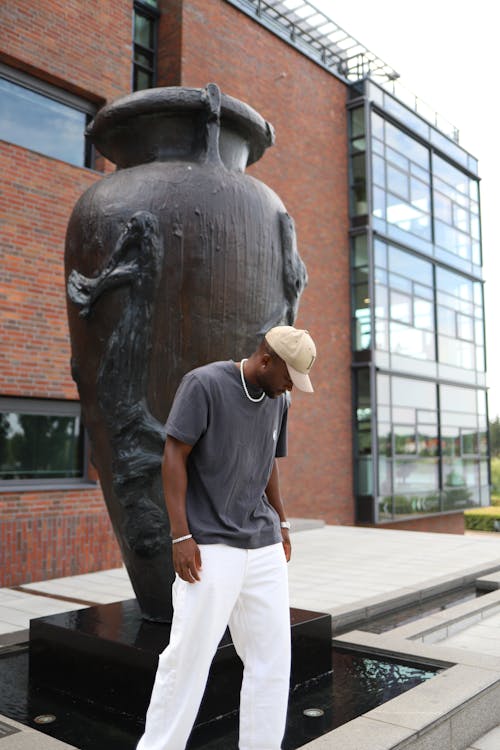 Man Standing near Sculpture