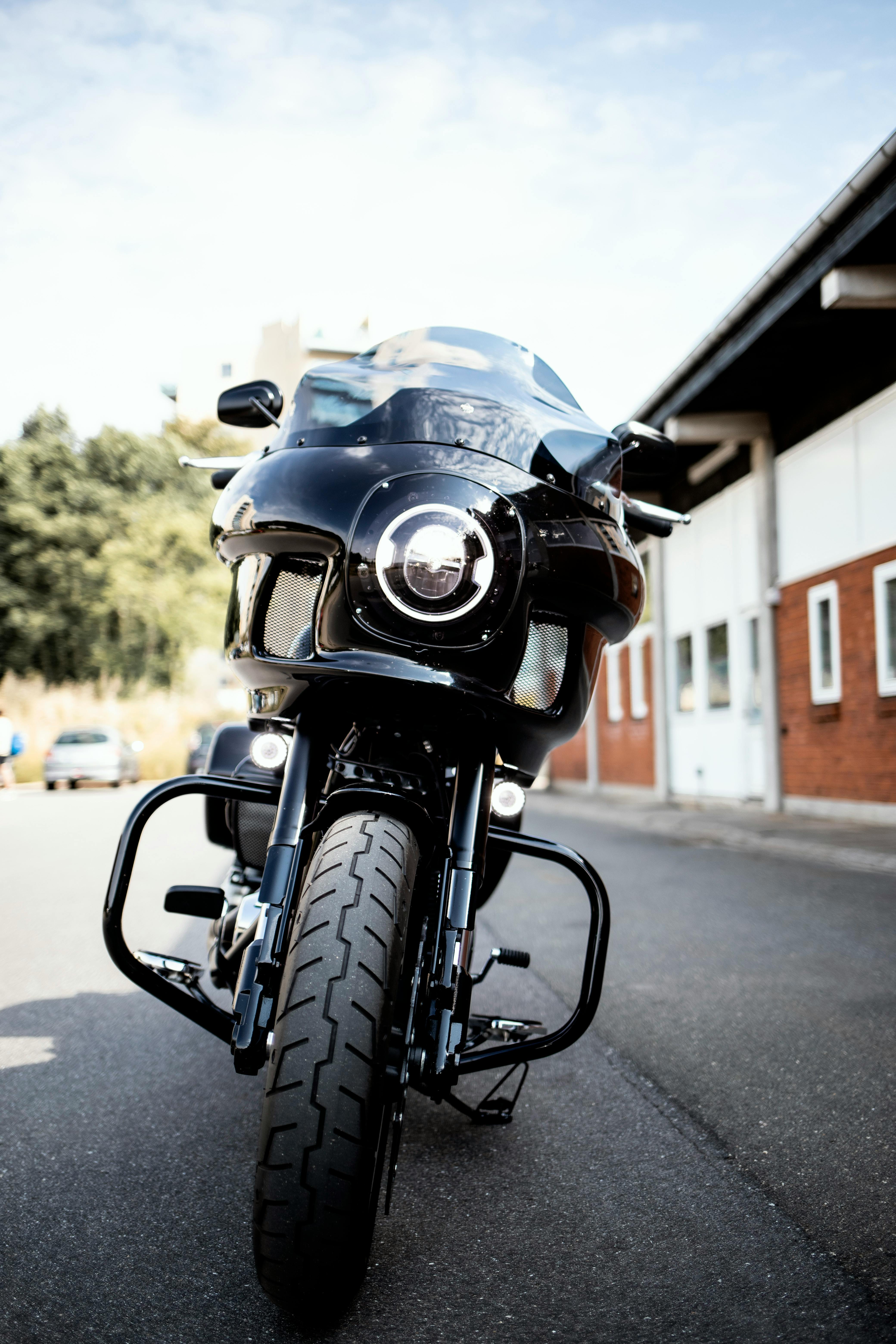 Free Stylish black motorcycle parked on city street, showcasing modern design in daylight. Stock Photo