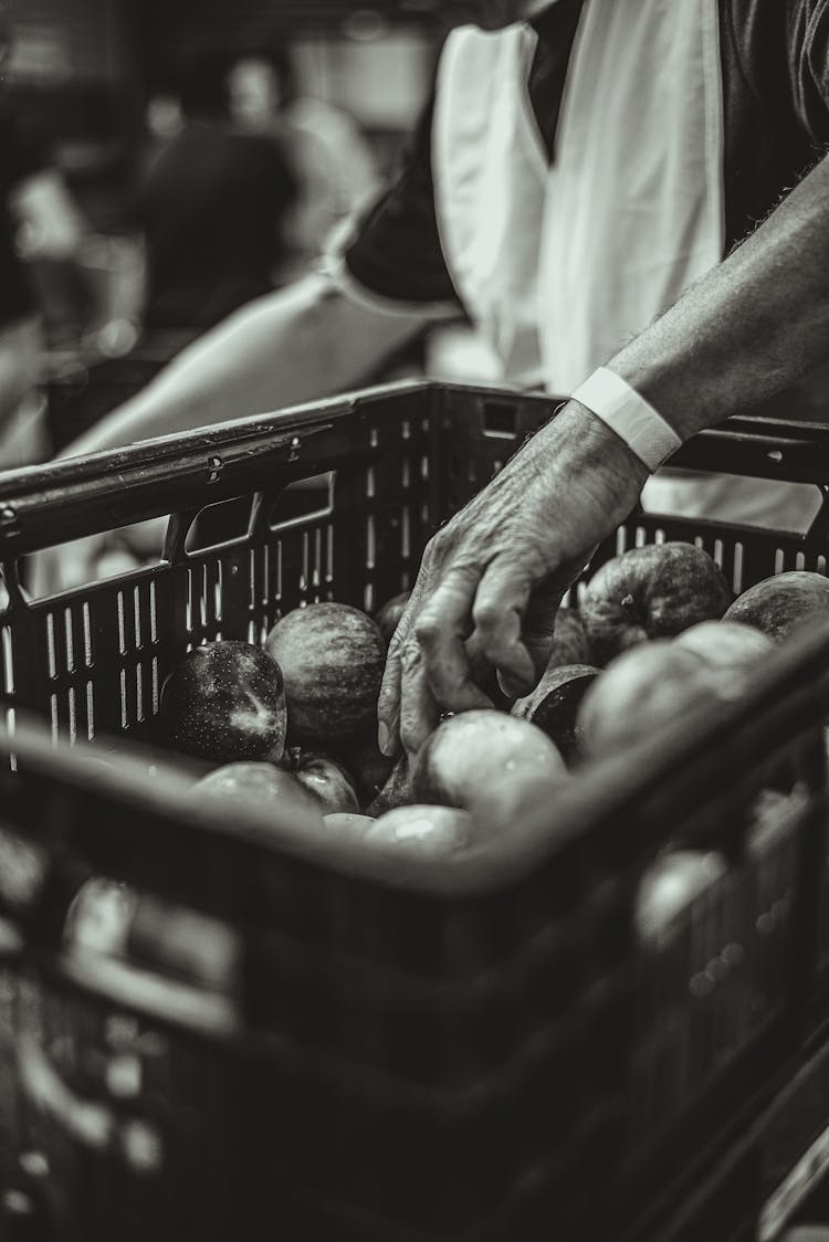 Person Grabbing Vegetable From Basket