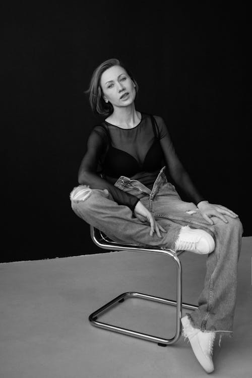 Woman Posing on Chair in Black and White