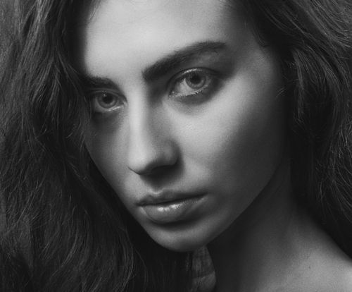 Free Striking black and white portrait featuring a young woman with intense gaze. Stock Photo