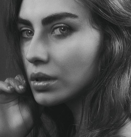 Free Close-up black and white portrait capturing the elegance of a woman with long hair. Stock Photo