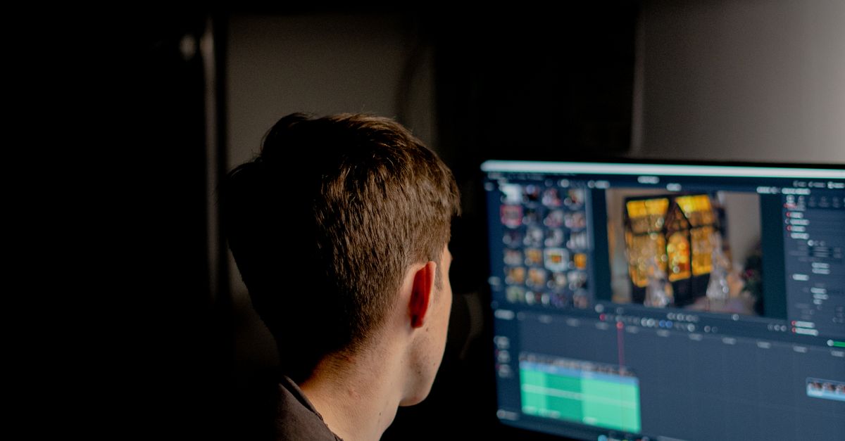 Man Editing a Film on the Computer · Free Stock Photo