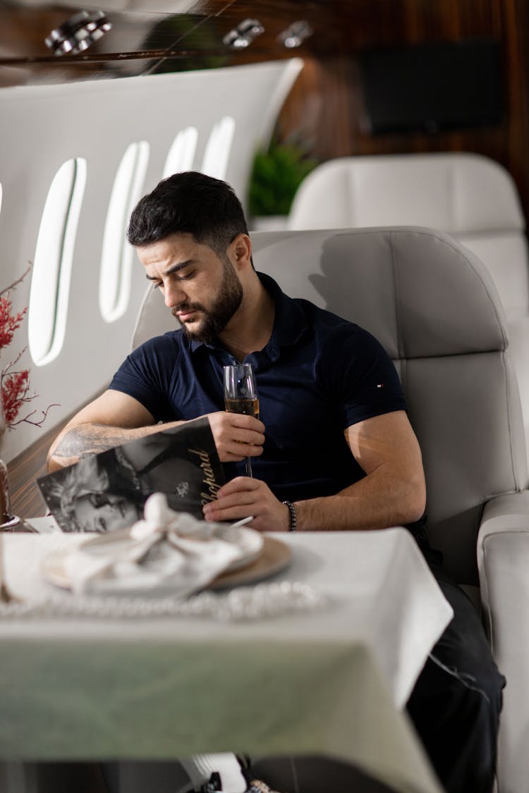 Man Sitting By Table On Airplane